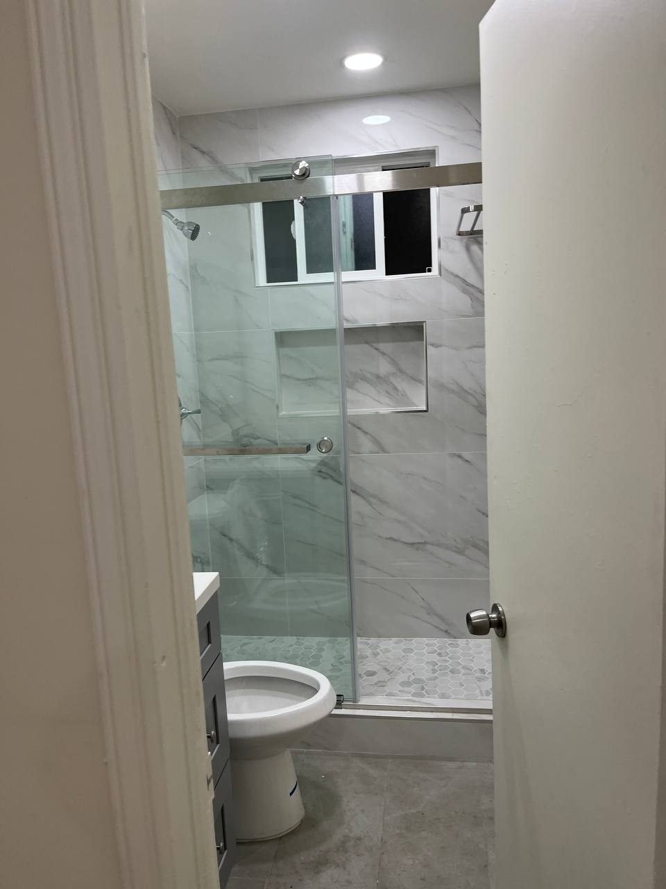 Completed marble shower bathroom remodel — Brick by Brick Renovations